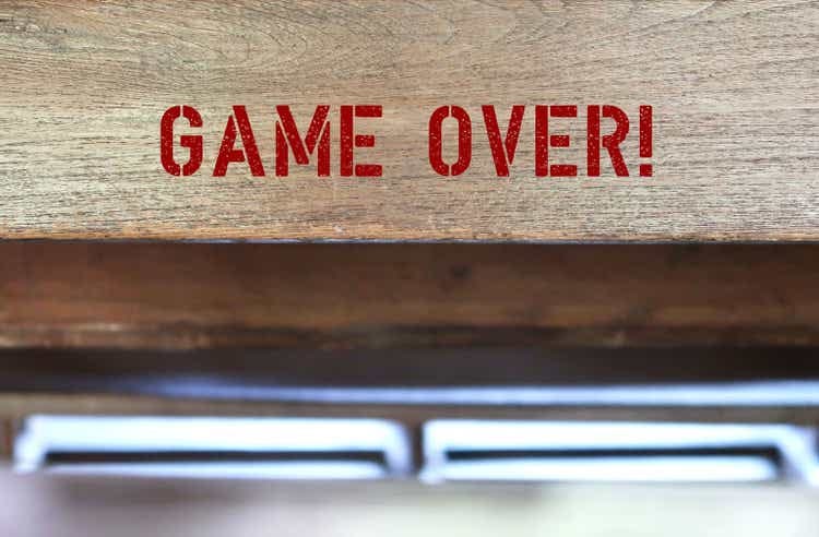 Wood background with blur copy space - red text GAME OVER! - to said when a situation is regarded as hopeless or irreversible - something come to an end and in a way unsatisfactory or unsuccessful