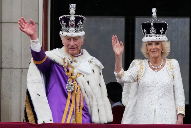 Britain's King Charles III and Queen Camilla wave to crowds from the balcony of Buckingham Palace after the coronation ceremony in London on May.