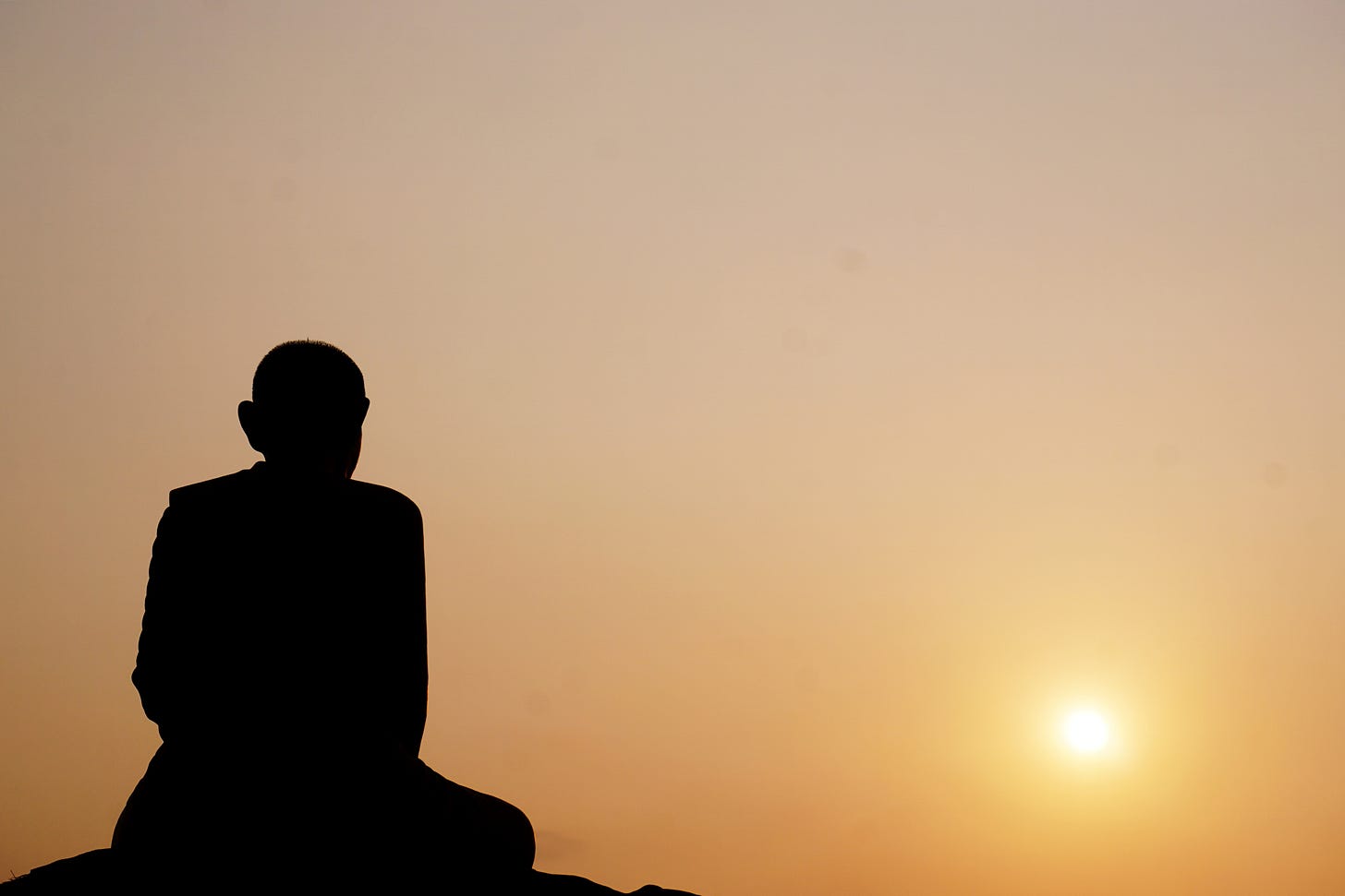 Photo of man looking into sun