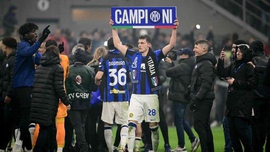 Inter Milan's French defender Benjamin Pavard (C) celebrates winning the 2024 Scudetto championship title(AFP)