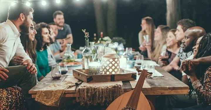 people sitting on chair in front of table with candles and candles people sitting on chair in front of table with candles and candles