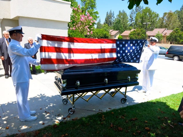 Folding the US flag after the funeral of the author's husband
