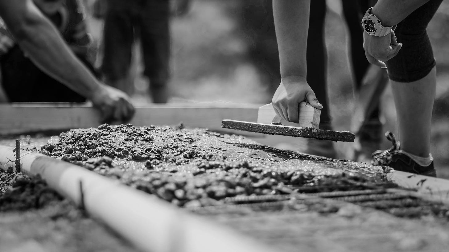 Closeup of people spreading cement