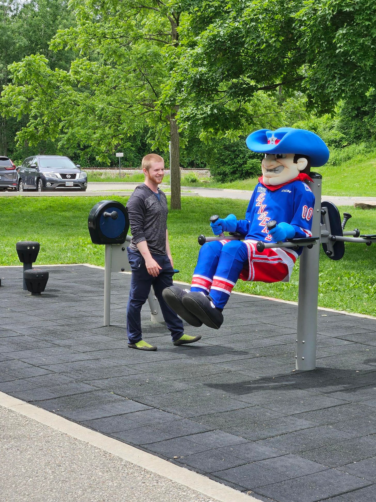 Kitchener Rangers mascot trying out the fitness equipment in Victoria Park