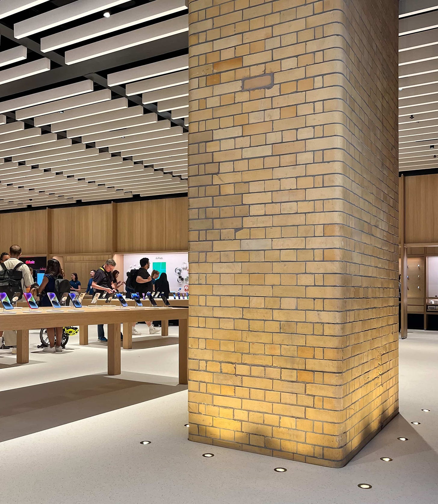 A large, historic brick column inside Apple Battersea.