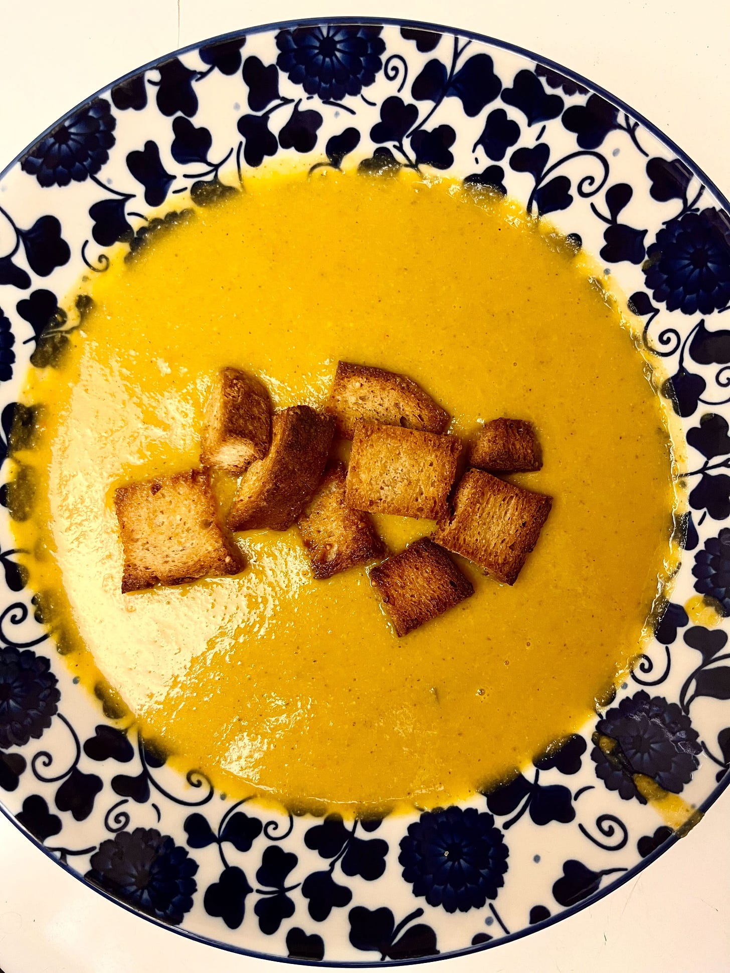 golden soup topped with croutons