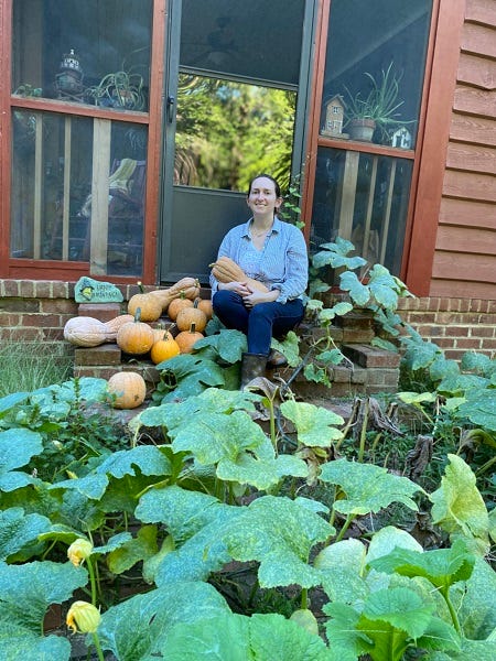 person sitting on brick steps with pumpkins and pumpkin vines