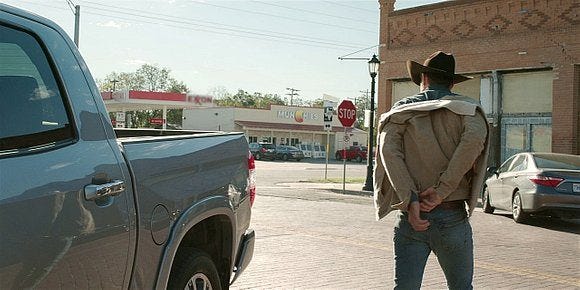 Liam putting jacket back on after turning tricks in the bus stop parking lot with Jared Padalecki.