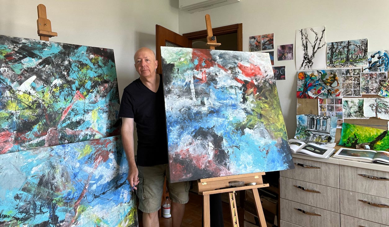 The author in his painting studio with three large canvases