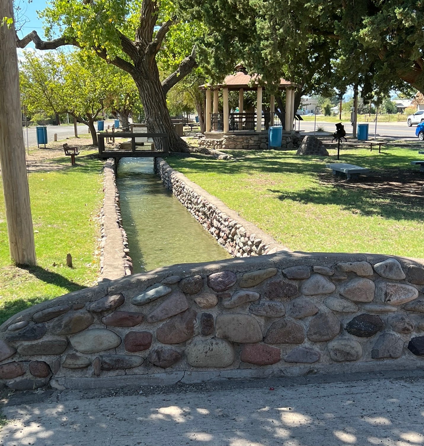 A stone bridge over a stream

Description automatically generated