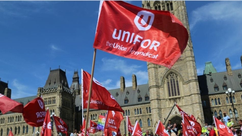 Unifor flags in front of Parliament buildings in Ottawa.