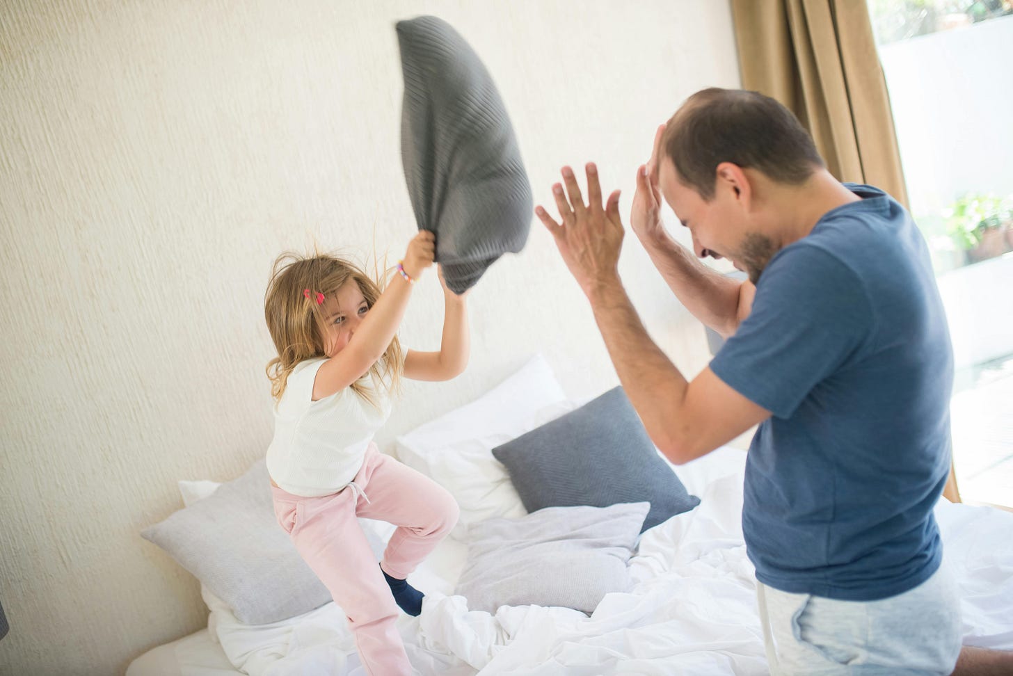 Girl Doing Pillow Fight with a Man · Free Stock Photo