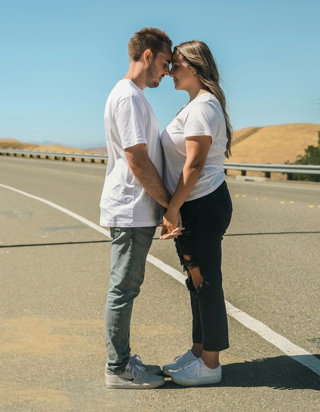 a man and woman kissing on a road a man and woman kissing on a road