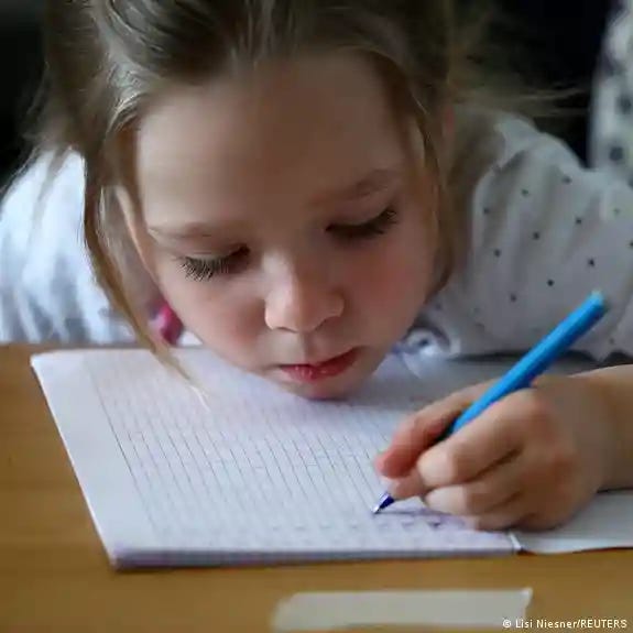 A school girl writing in a book