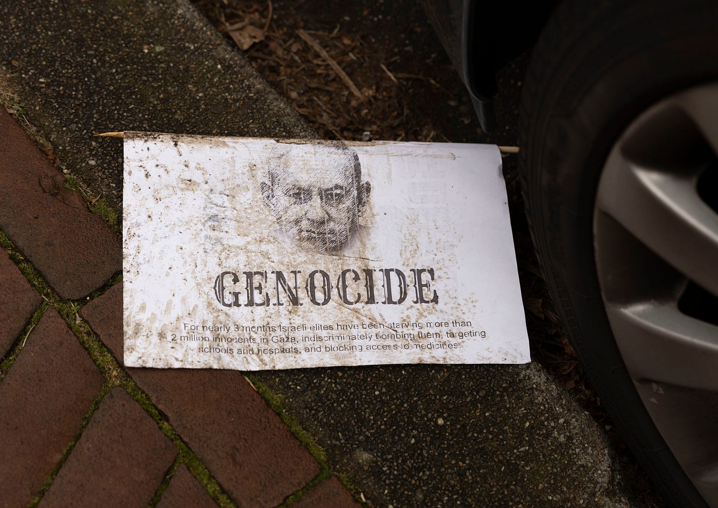 THE HAGUE, NETHERLANDS - JANUARY 12: A leaflet with a drawing of Israeli Prime Minister Benjamin Netanyahu and the text 'genocide' lies on the curbside in front of the International Court of Justice on January 12, 2024 in The Hague, Netherlands. On January 11 and January 12 at the International Court of Justice (ICJ), the judicial body of the United Nations, in The Hague, South Africa seized the ICJ, to ask it to rule on possible acts of "genocide" in the Gaza Strip by Israel. (Photo by Michel Porro/Getty Images)