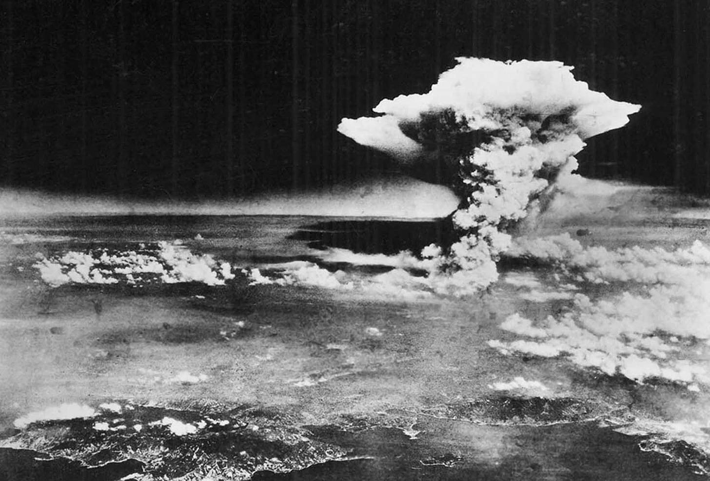 On August 6, 1945, a mushroom cloud billows into the sky about one hour after an atomic bomb was dropped by American B-29 bomber, the Enola Gay, detonating above Hiroshima, Japan. Nearly 80,000 people are believed to have been killed immediately, with possibly another 60,000 survivors dying of injuries and radiation exposure by 1950.