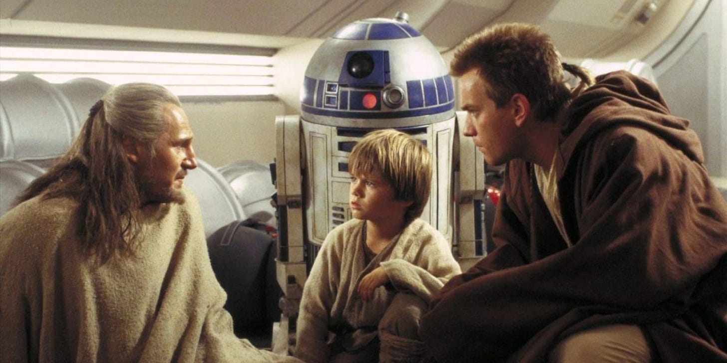 Qui Gon, R2-D2, Anakin, and Obi-Wan talk in Anakin's home