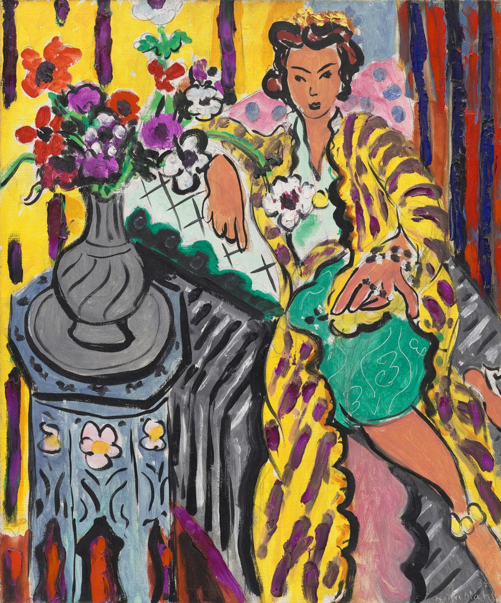 Matisse painting of woman in a colorful robe with a big vase of flowers