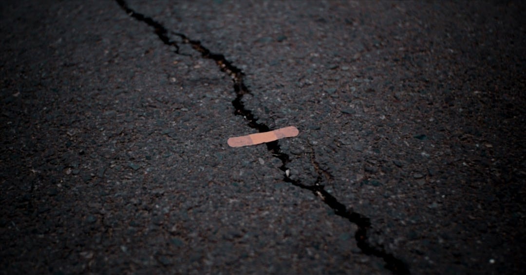 orange band aid on concrete surface crack orange band aid on concrete surface crack
