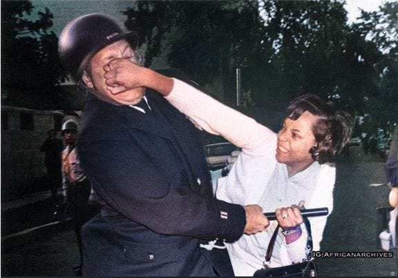 This may contain: an old photo of a baseball player being hugged by a woman