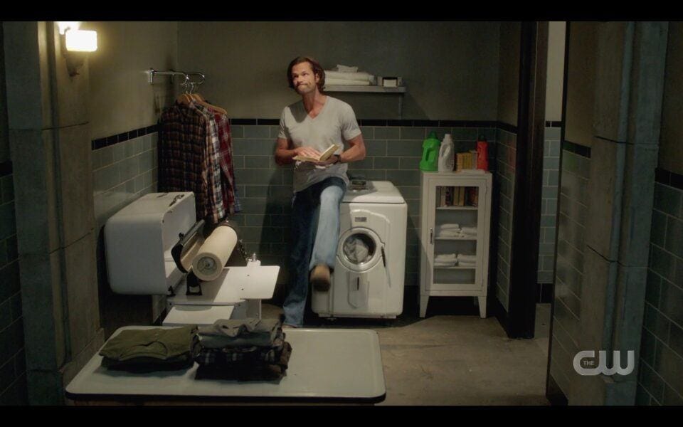 SPN Sam Winchester sitting on washer kicking it