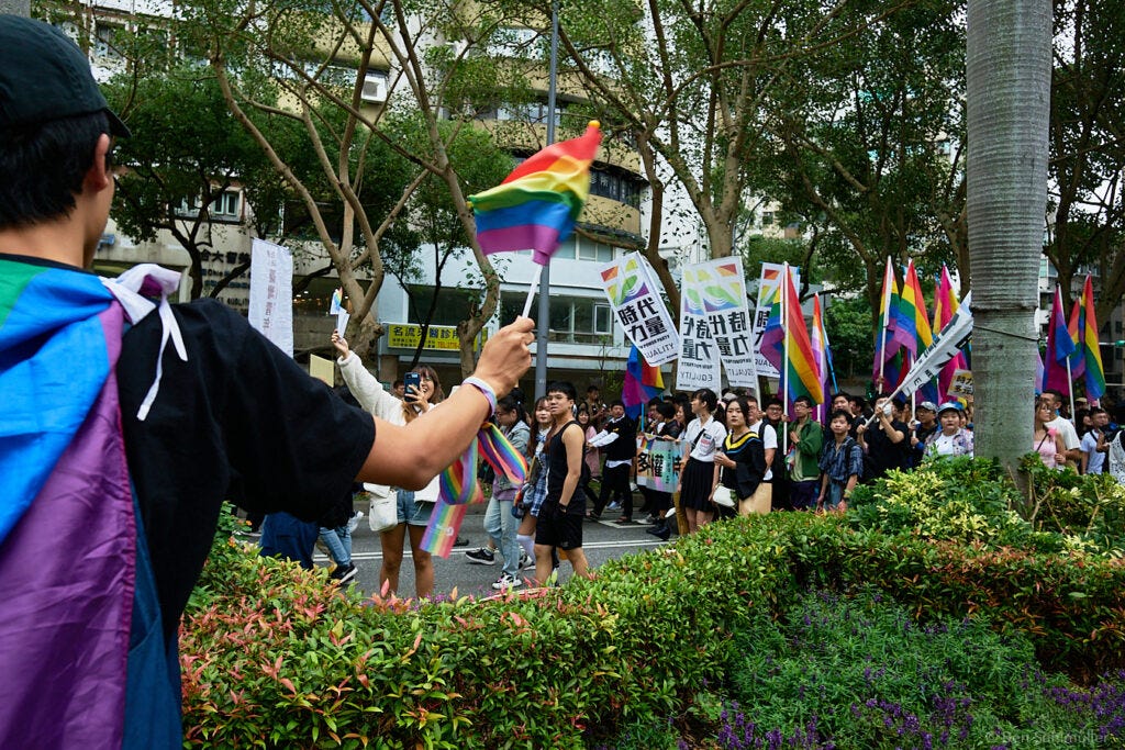 A crowd of people holding rainbow flags at Taiwan Pride 2023.