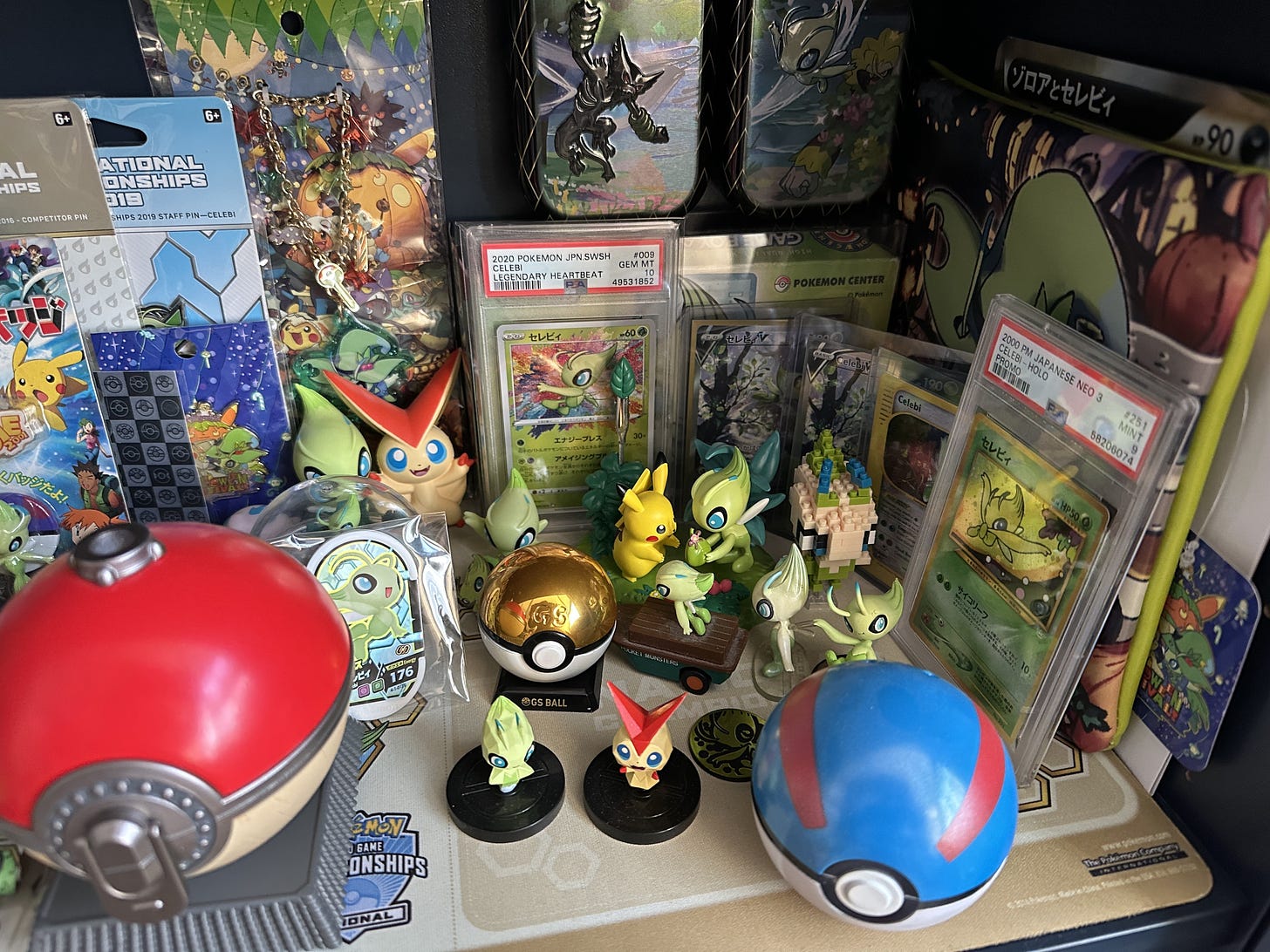 More items from Joe's collection of items include cards, figures, and Poké Balls, including a special GS Ball