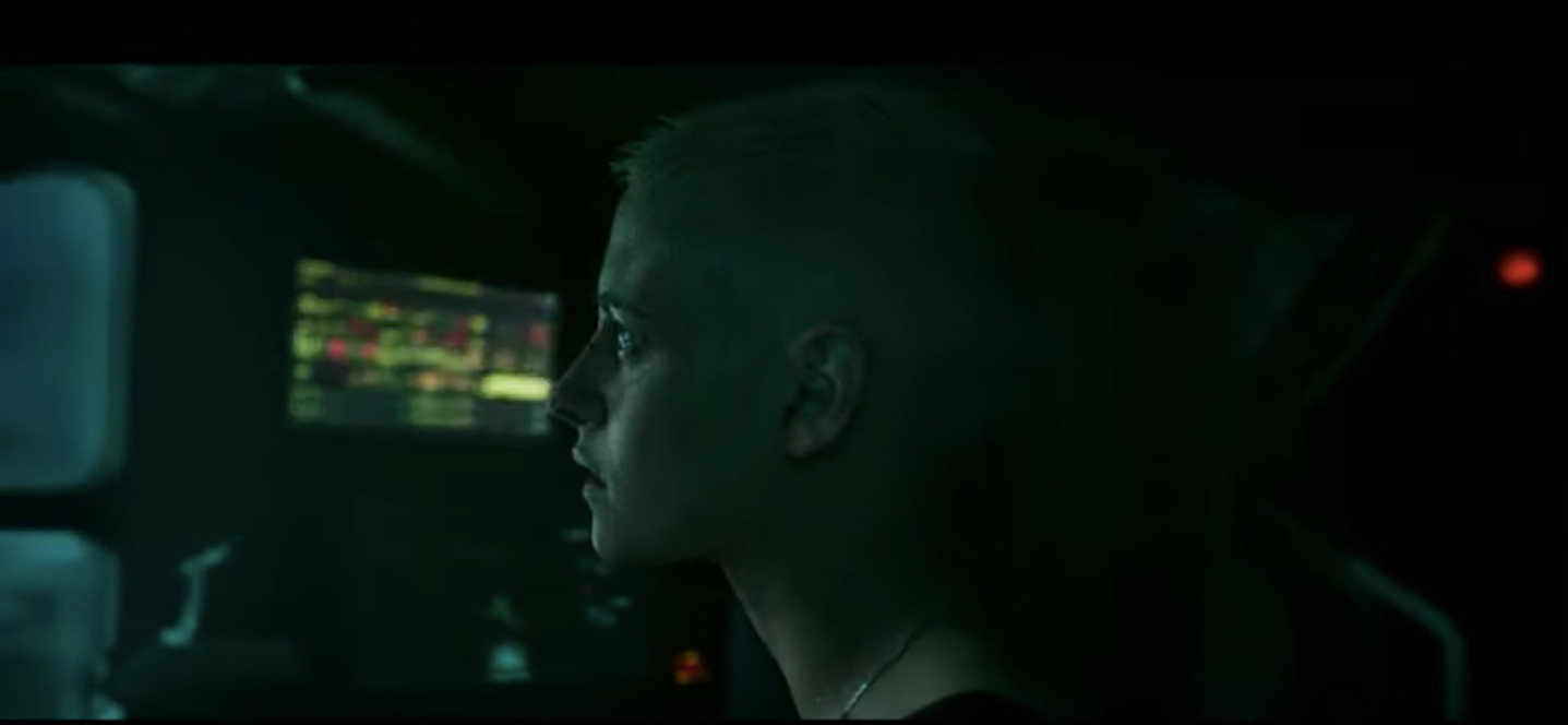 Kristen Stewart again looking offscreen in front of a bunch of red and green lights. Looking tragic still.