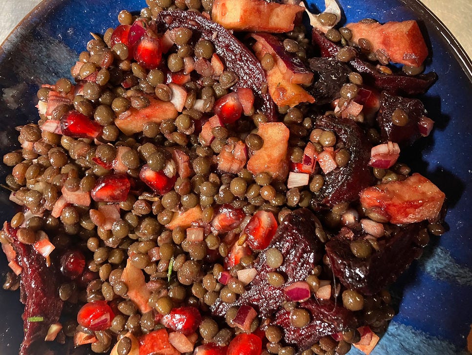 Lentils with cumin-roast beetroot, apple, black olives and pomegranate seeds