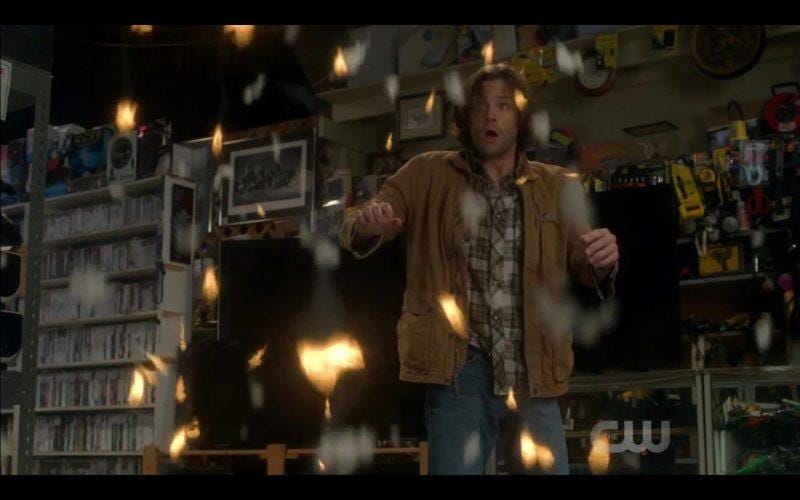 supernatural sam winchester fighting off fire in sky shop