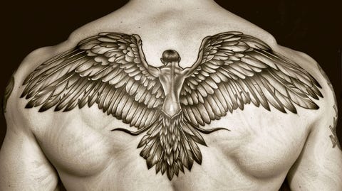 Image of a strong and powerful guardian angel tattoo on the back of a man.