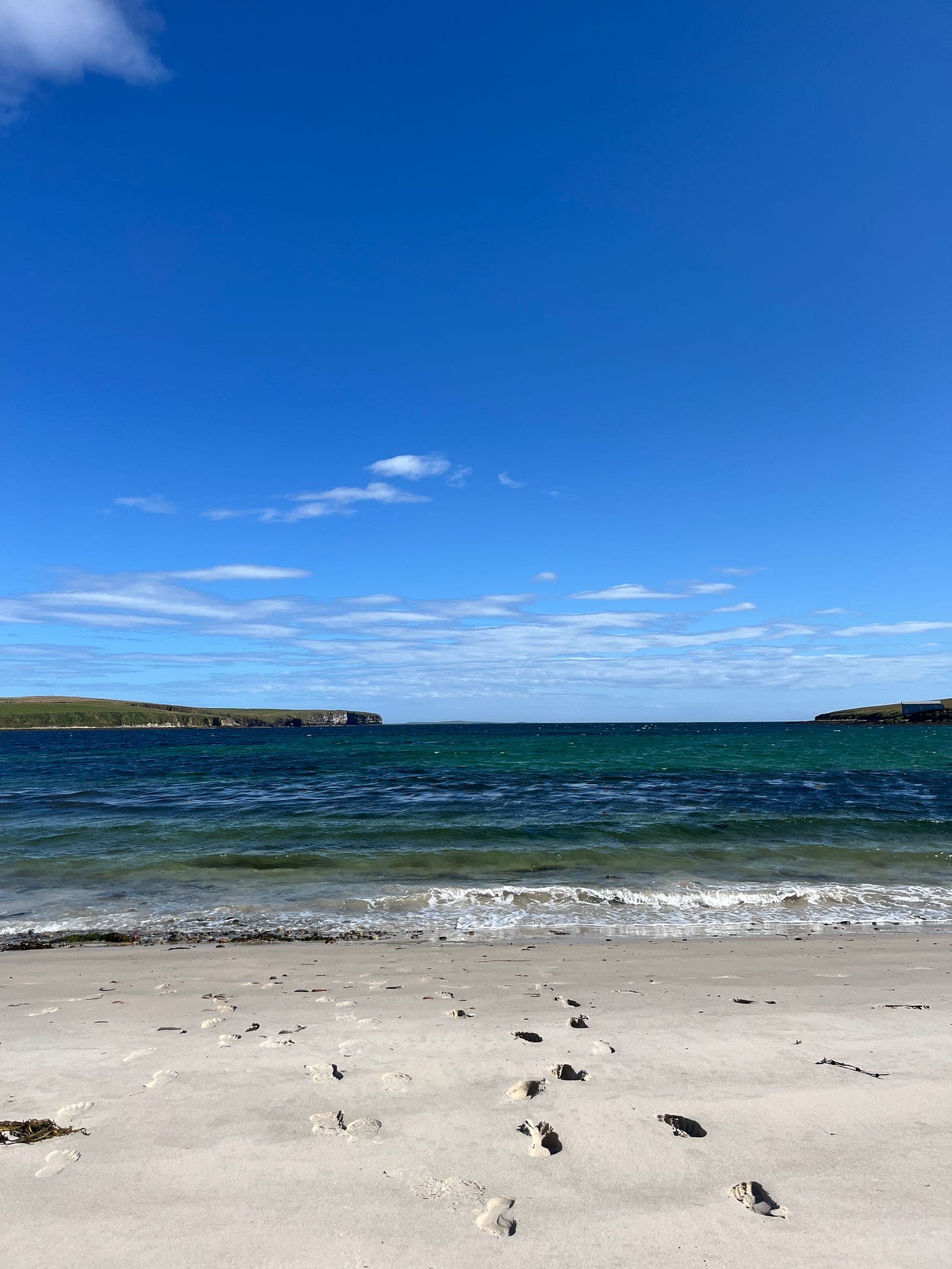 Image of a sandy beach on Hoy, glorious blue sunshine & footsteps towards the sea