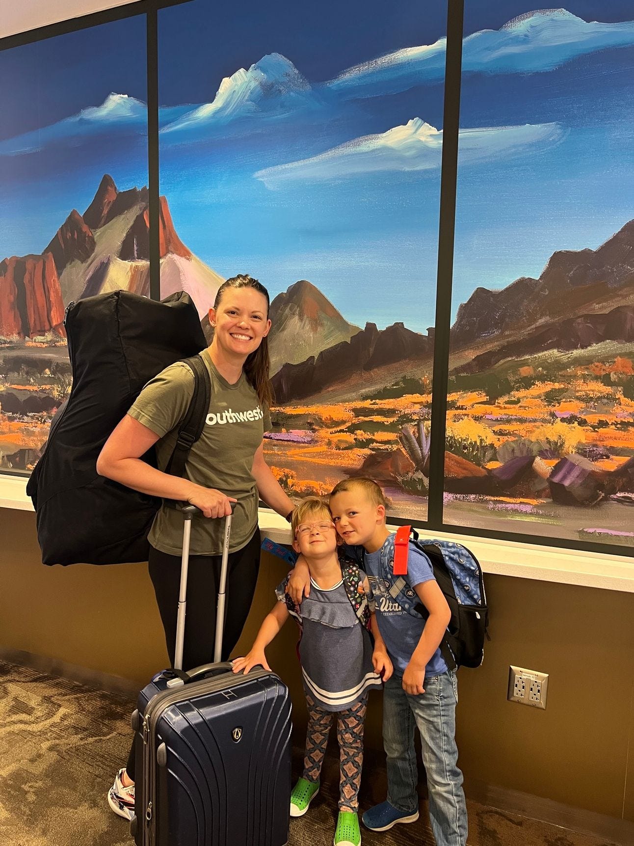 a woman and he kids traveling through the airport a woman and he kids traveling through the airport