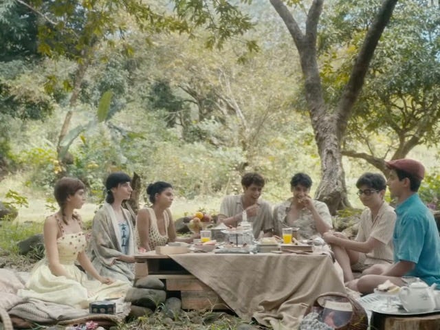 A still from Hindi film, ‘The Archies’. 7 teenagers having a picnic meal.