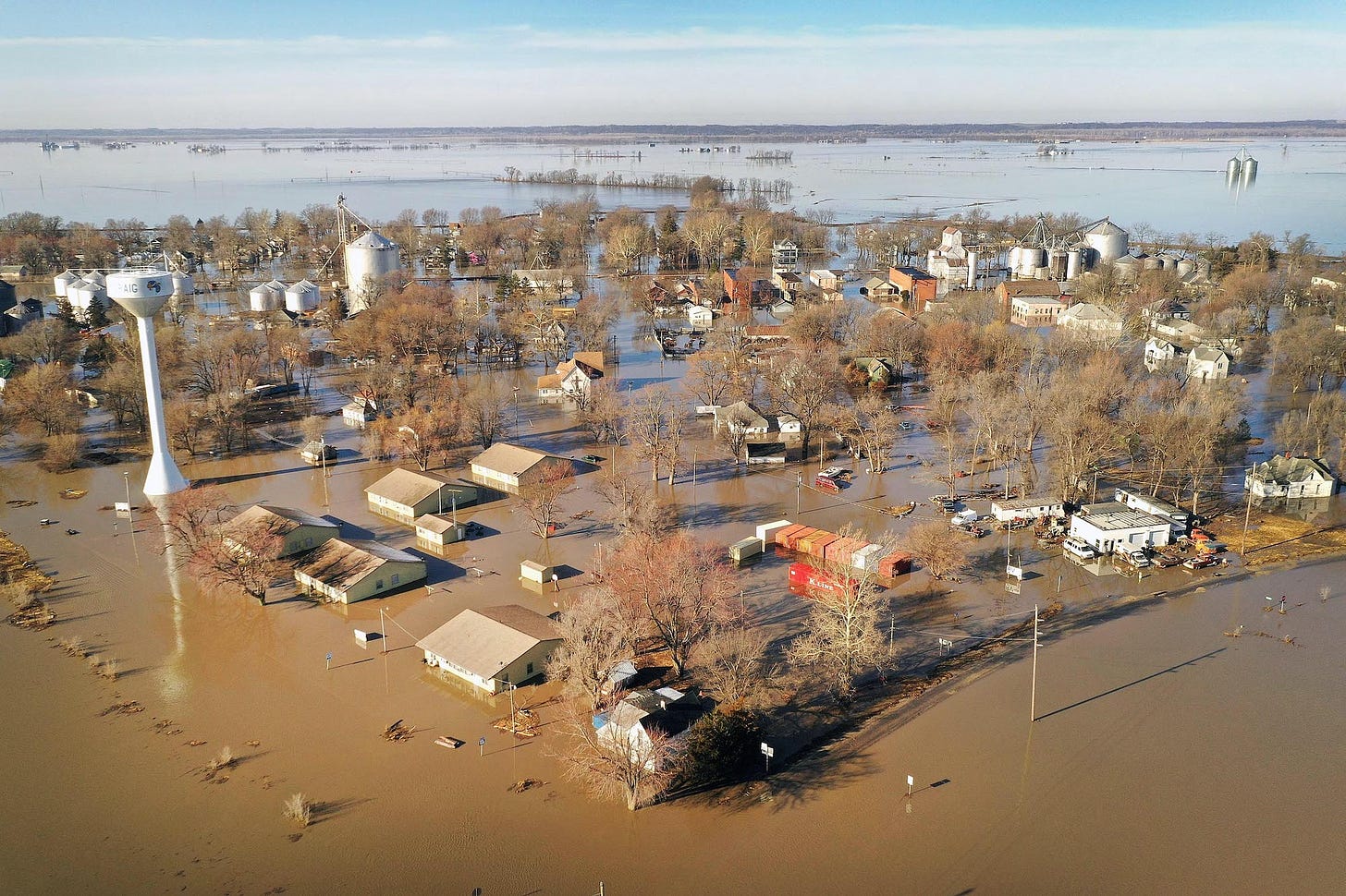 Aerial view of farm and small rural community submerged by flooding.