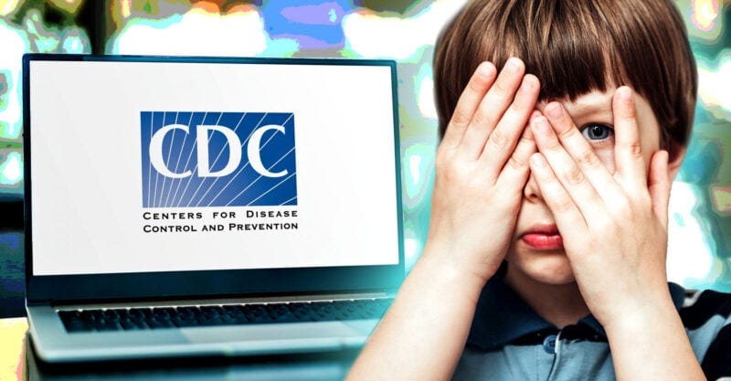 laptop with cdc logo on it and boy covering one eye