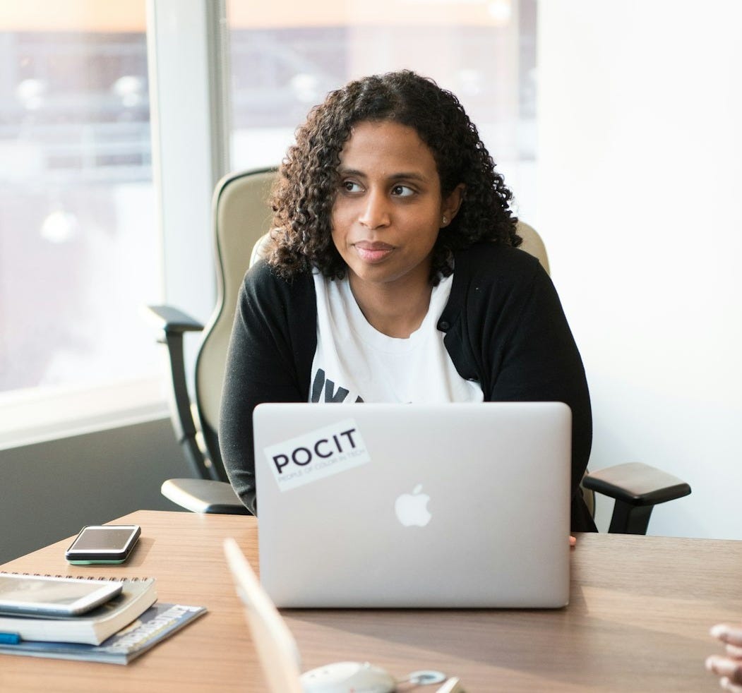 woman sitting beside laptop woman sitting beside laptop