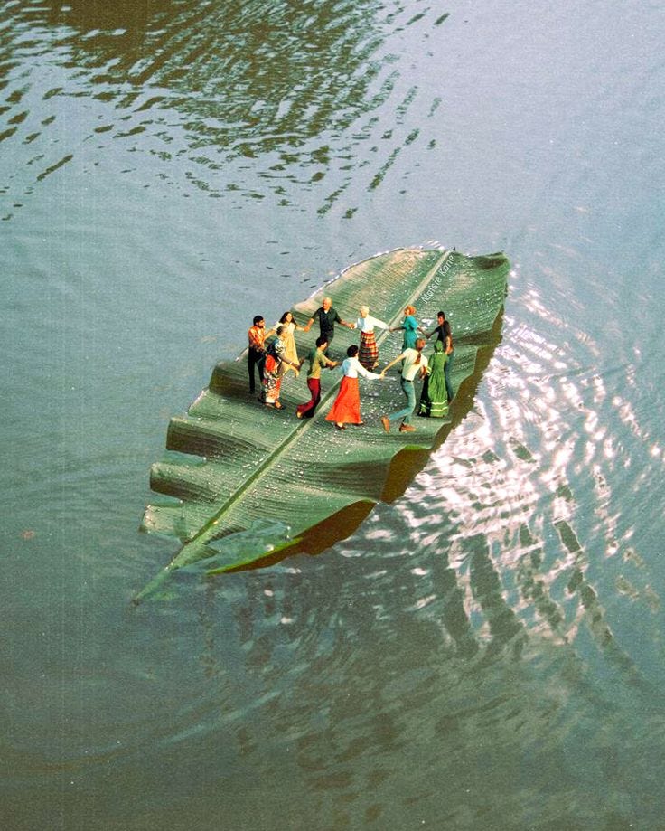 A group of people holding hands and dancing on a leaf floating in the water