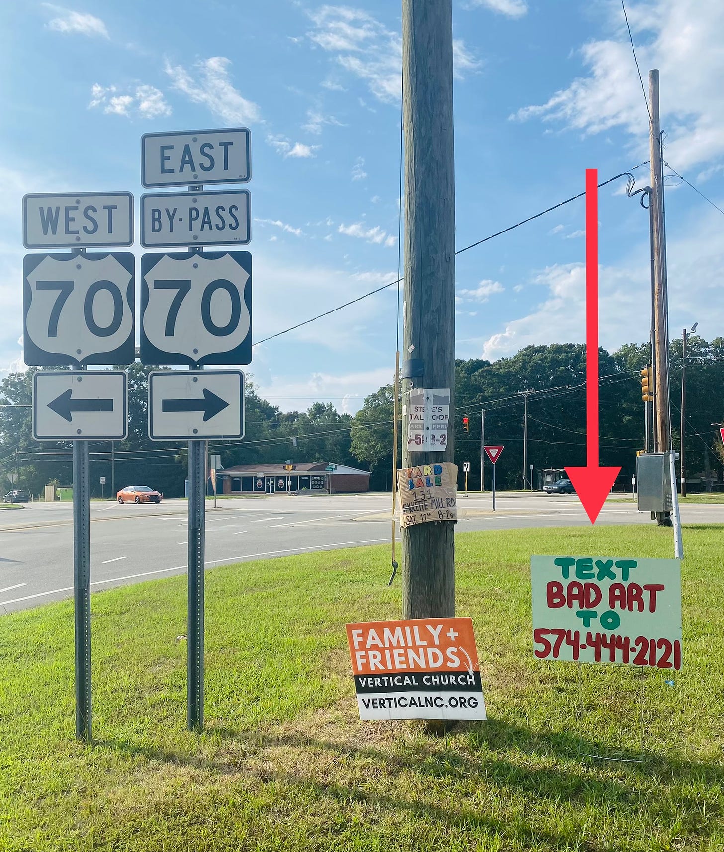 An image of a road sign that reads "Text Bad Art to 574-444-2121" on the side of the road in Hillsborough.
