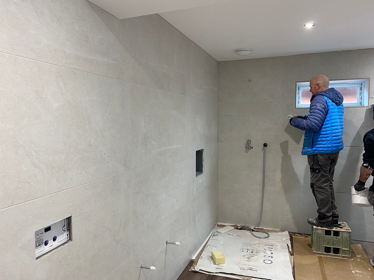 man grouting wall tiles