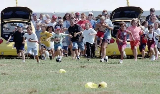 Children run desperately to catch a plush Pikachu toy at Forbes Field, Topeka on August 27th 1998 (Photo credit: Nik Wilets, The Capital-Journal)