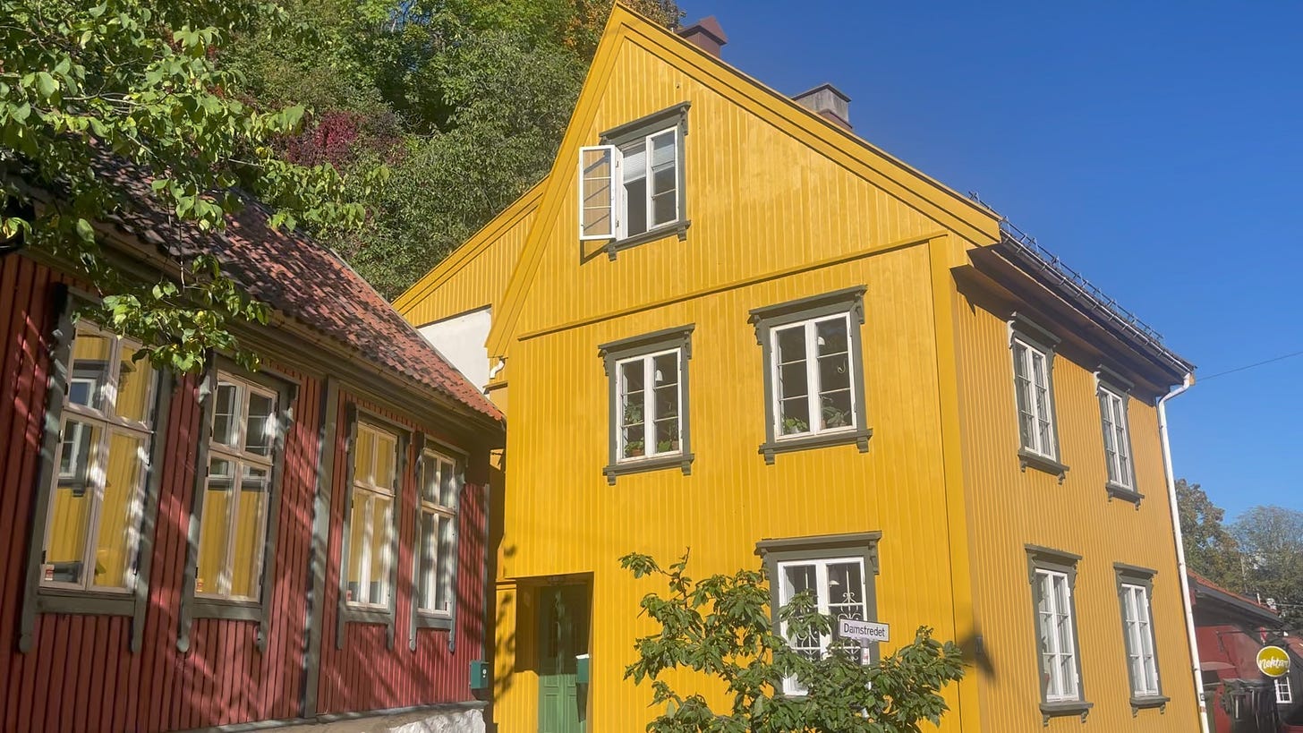 A bright yellow wooden house against the blue sky