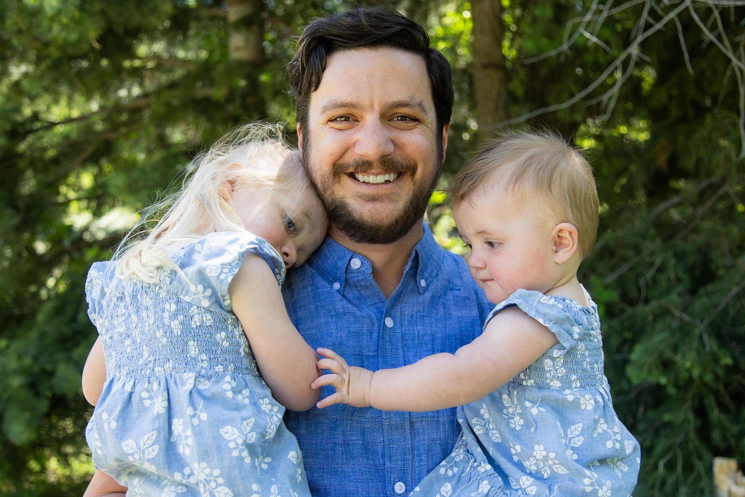 Scott Houghton, founder of The Screen-Free Dad holding his two daughters.