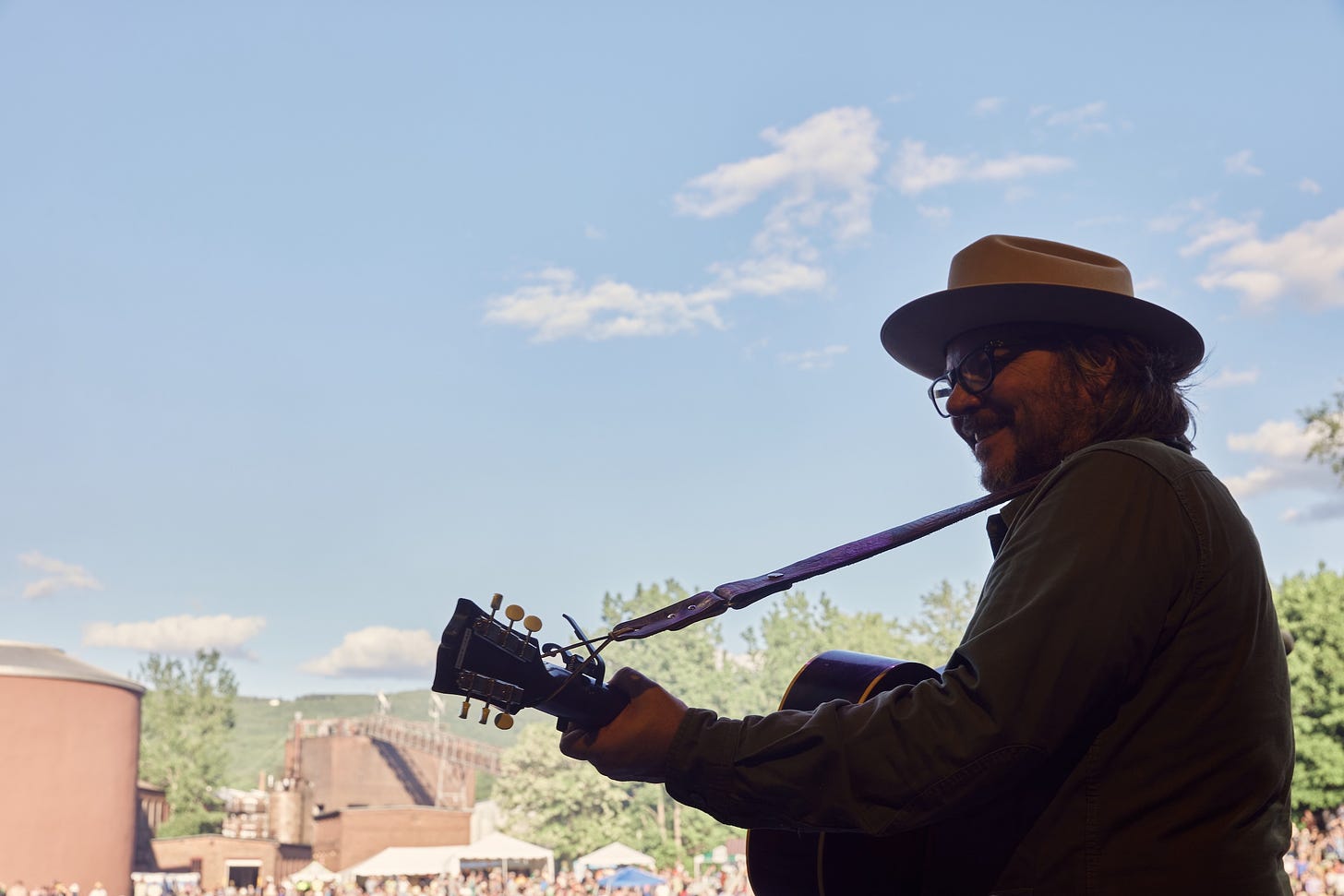 man in cowboy hat with guitar on stage