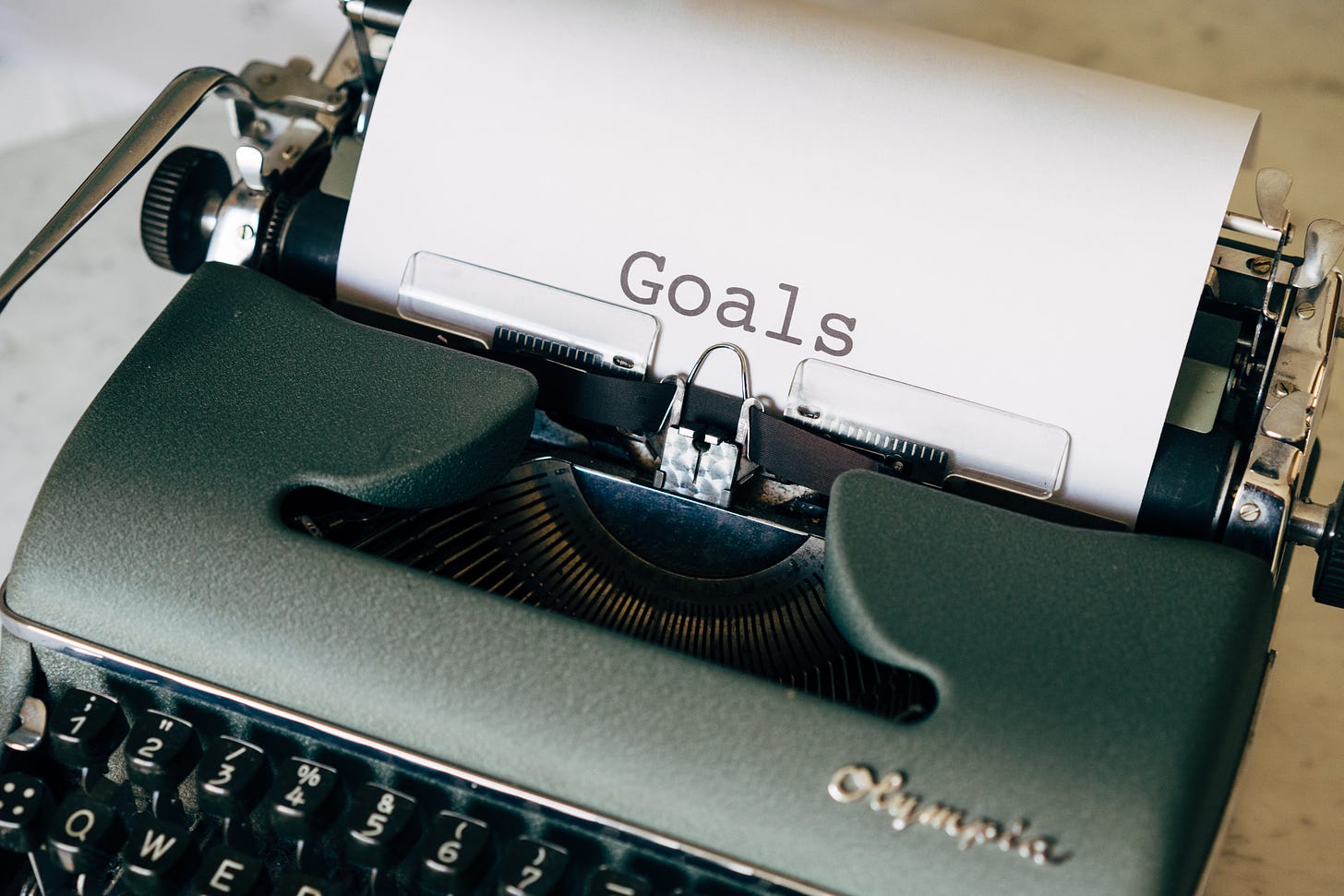 Typewriter printing paper that reads "goals"