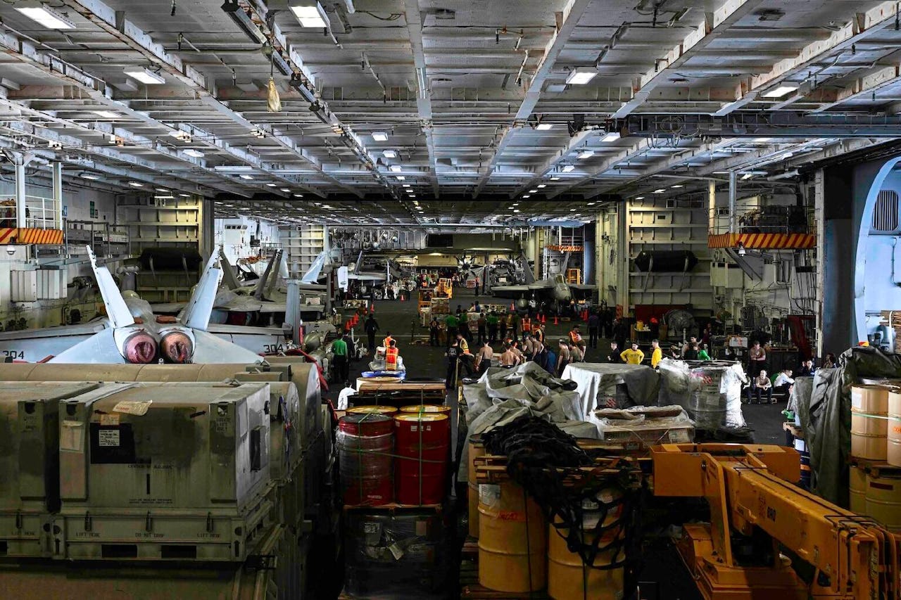 Cargo clogs up the hanger deck of an aircraft carrier.