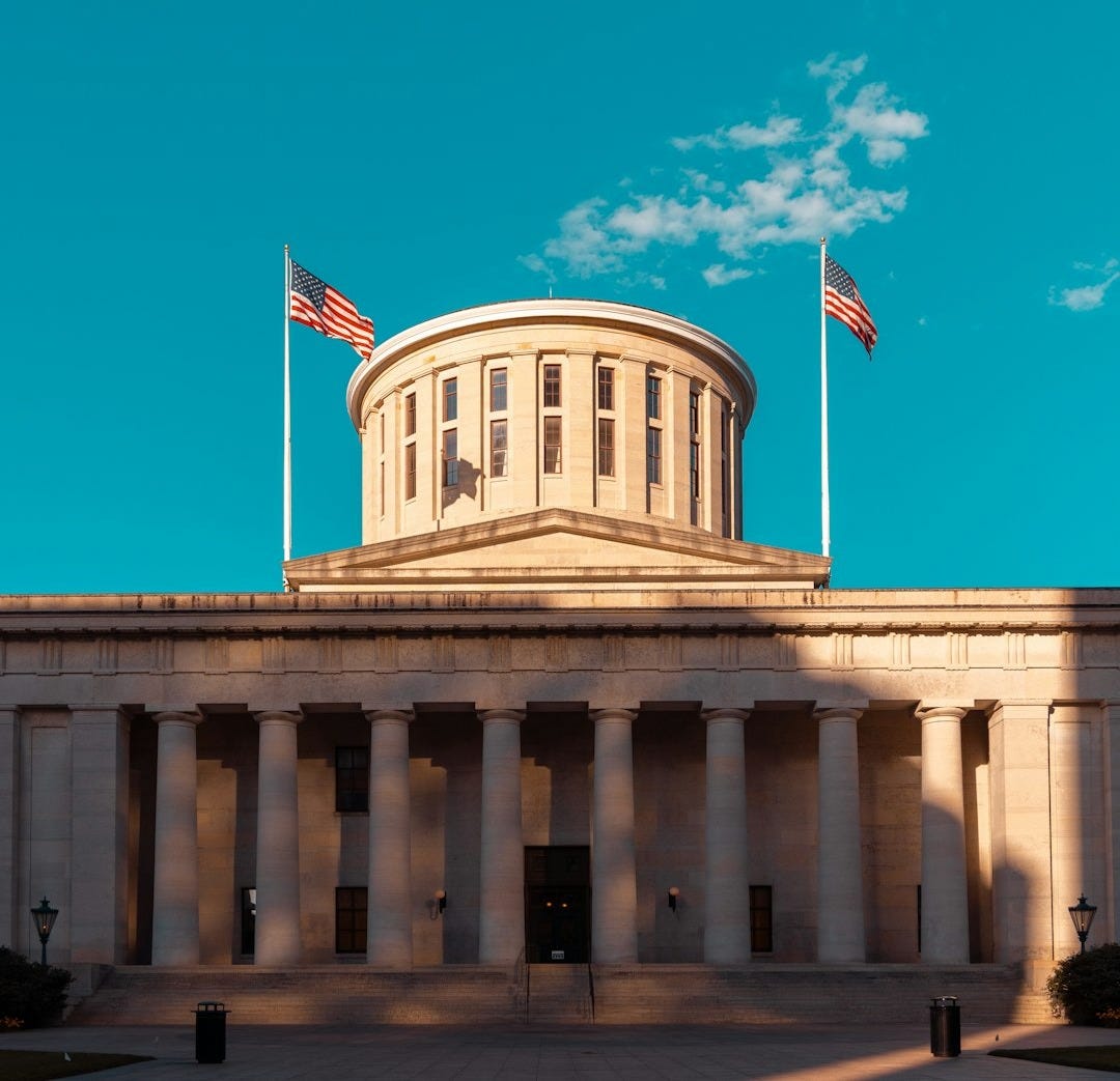 a building with two flags on top of it a building with two flags on top of it