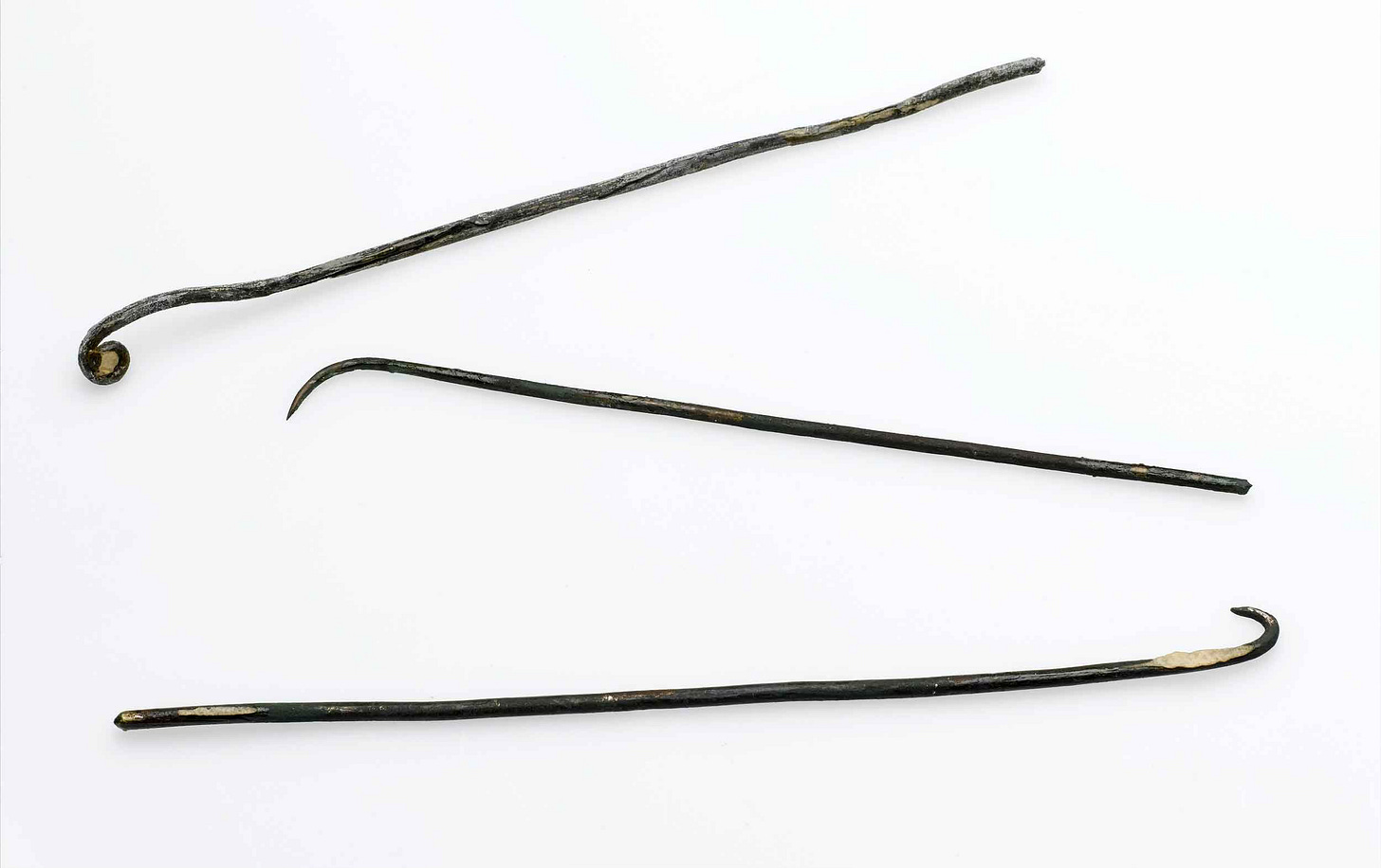 Three long bronze hooks