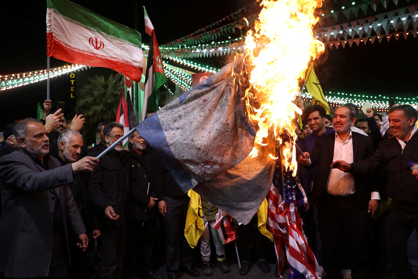 Iran and Israel have been caught in a cold war of sorts for years (Pictured: Iranians burning an Israeli flag)