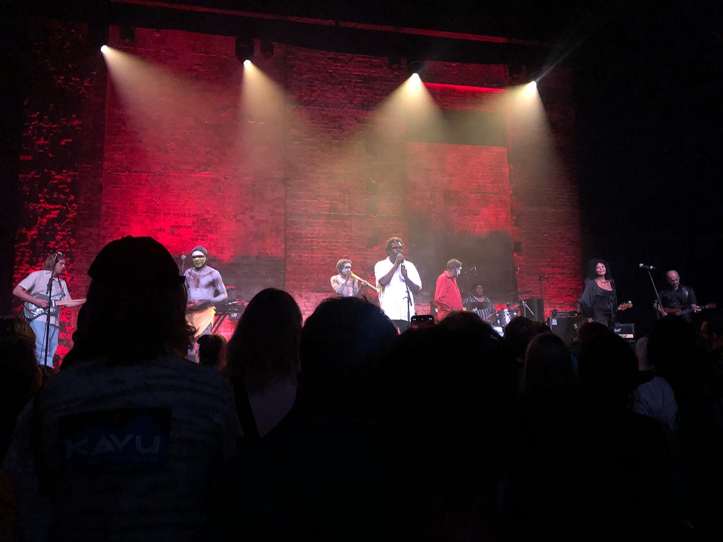 spotlights shining down on band, Yothu Yindi 